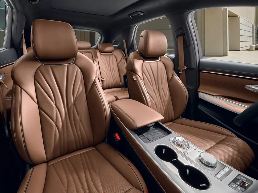 2026 Genesis GV70 SUV interior with premium brown leather seats and luxury cabin design