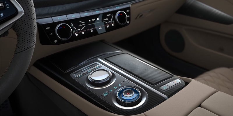 The car's center console with climate controls and a gear selector.
