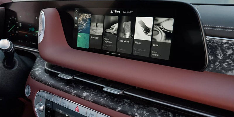 The central display screen inside a car, showing various app icons.