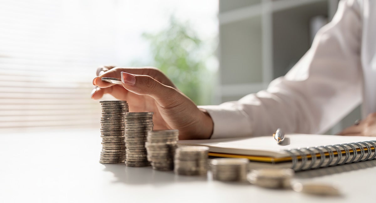 Man arranging coins on a table.
